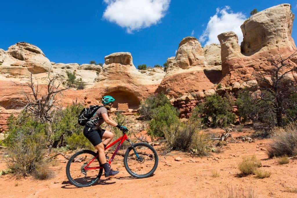 Woman biking near ancient cliff dwellings in SW Colorado near Cortez at Sand Canyon