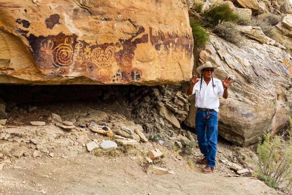 Tour guide explaining petroglyphs in Ute Mountain Tribal Park